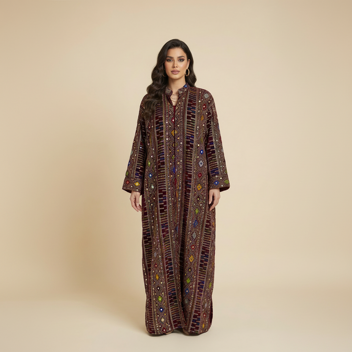 Woman wearing Punjabi a long, patterned dress against a beige background